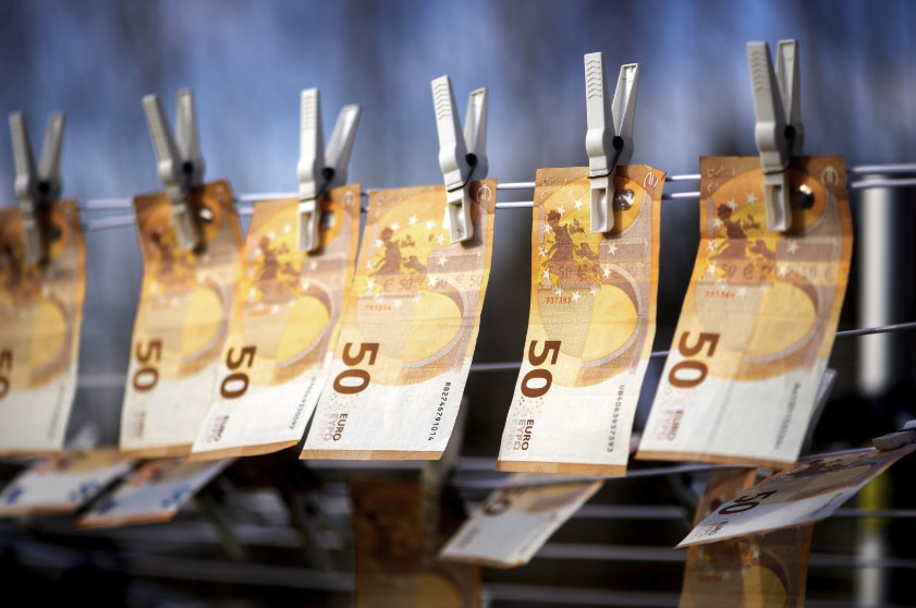 Close-up photo of 50 euro banknotes suspended from a clothesline