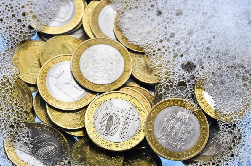 Gold coins in soapy water